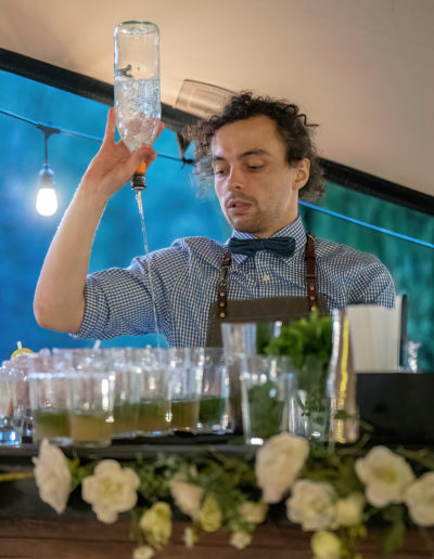 a barman pouring cocktails shot by surrey social stock photography